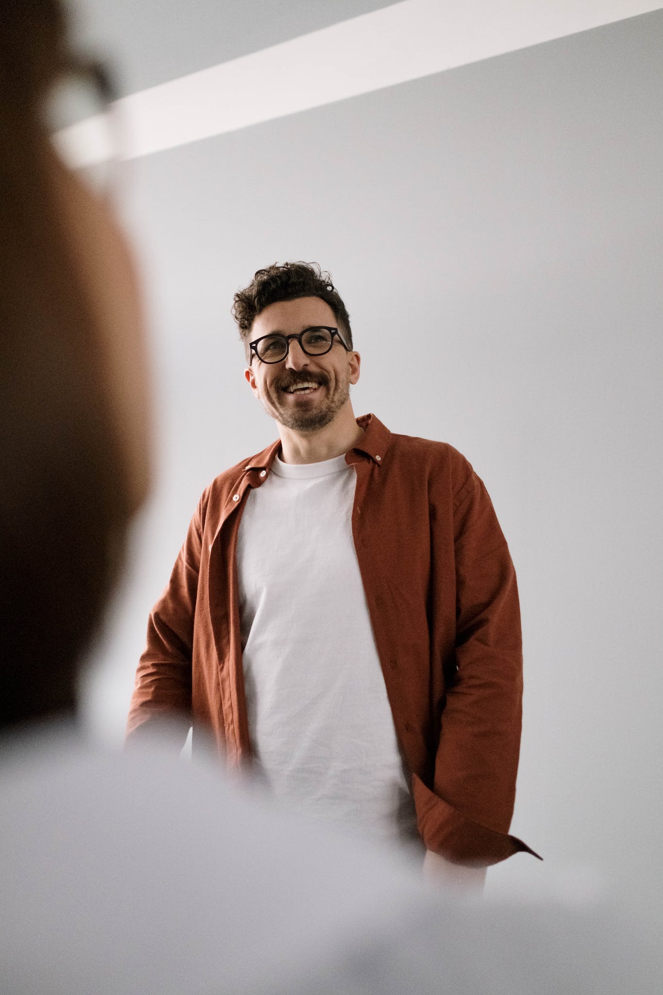 Man in Brown Dress Shirt laughing